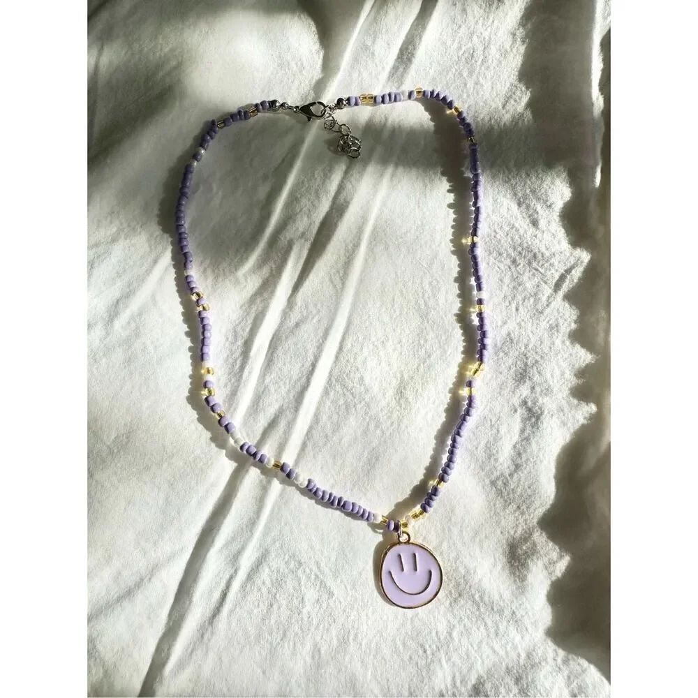 Light purple color beaded beach necklace with smiley face charm